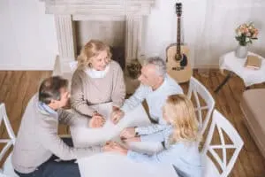 people praying at table; godly friend