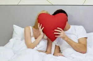 couple in bed with red heart; Proverbs 31:12