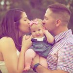 image of mother and father kissing baby's head between them for the post Christian Parenting: 10 Simple Tips For When You Don't Agree