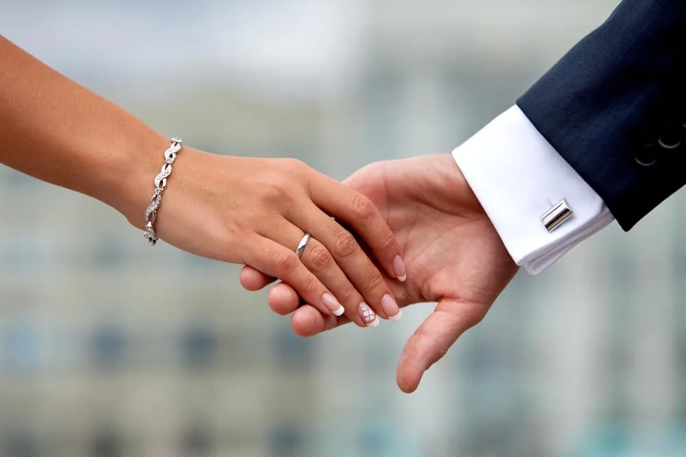 picture of man and woman touching hands for post why a Christ centered marriage may not be what you think it is