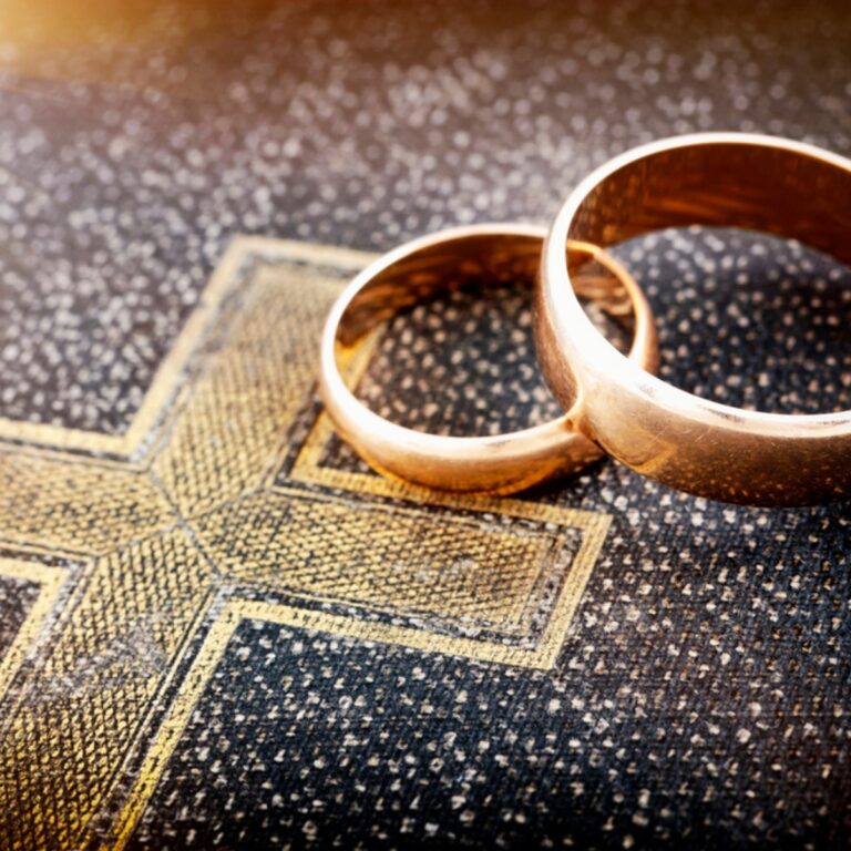image of wedding rings on Bible for the post on a Christ centered marriage