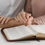 image of a man and woman holding hands while reading the bible for the post The Fruit of Her Hands