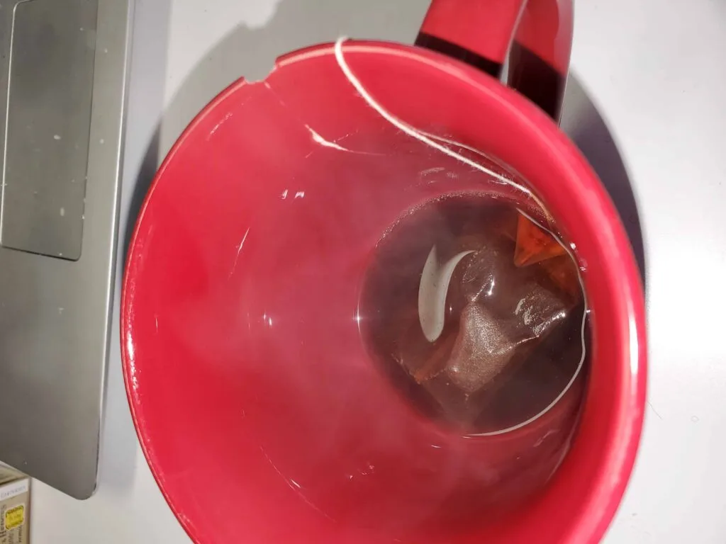 teabag in cup with small amount of water for painting with tea