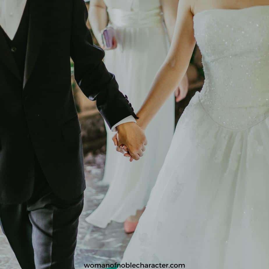 image of couple on wedding day holding hands for the post Why Must I Change First? Marriage Isn't 50-50
