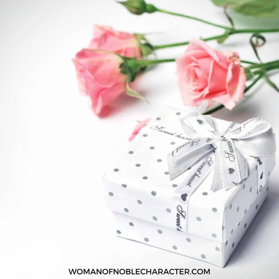 image of polka dot wrapped gift with pink rose stems in background for the post Best Gifts for Christian Women