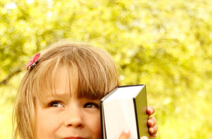 little girl hugging Bible for the post 25 Best Bible Verses for Children to Memorize