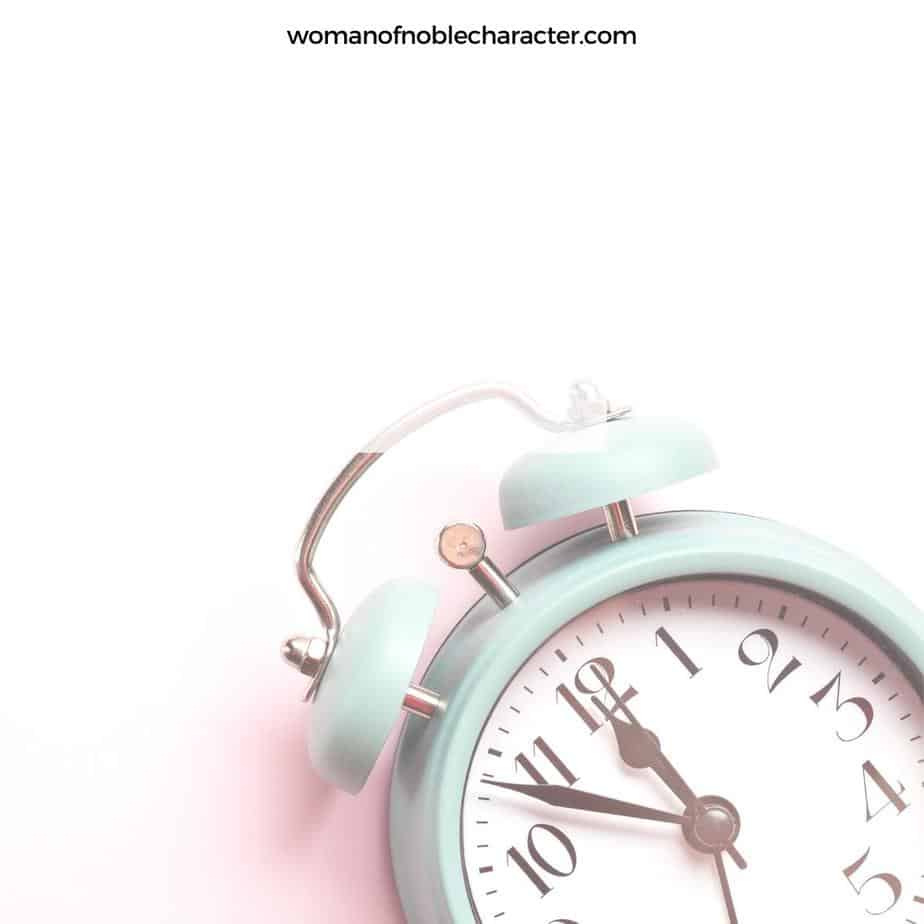 image of pale blue clock on pink background for the post 3 Simple Tips for Spending Time with God (when life is super busy)