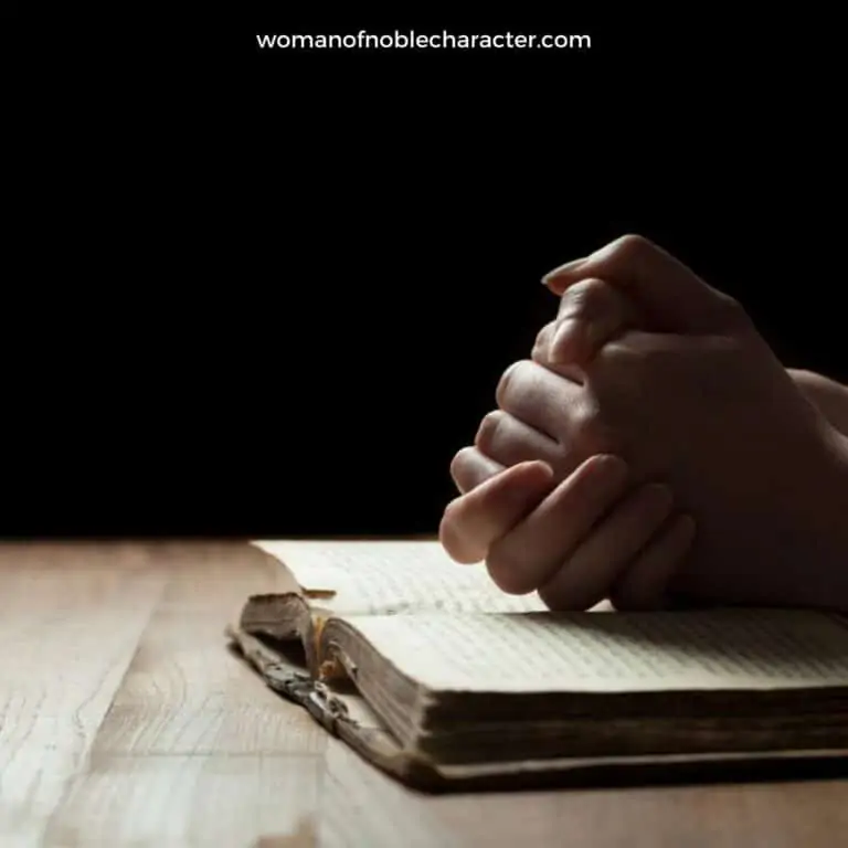 image of hands folded over open Bible for the post The Complete Guide to Praying for Your Husband
