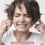 image of woman with fingers in ears for the post How to Deal with Negative Thoughts and Self-Talk
