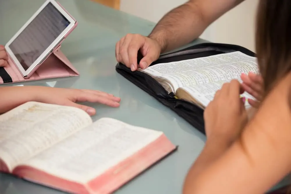 Close-up of People Reading the Word of God together; studying Bible characters