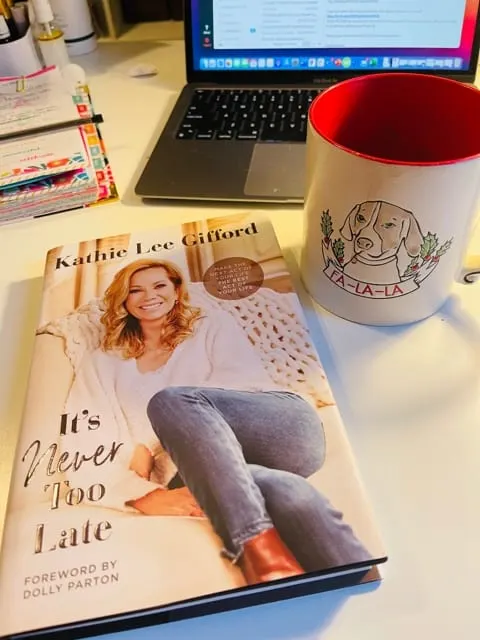 It's Never Too Late by Kathie Lee Gifford on desktop with computer and coffee cup