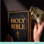 image of hand tucking money into Bible for the post 4 Ways to Invite God Into Your Personal Finances