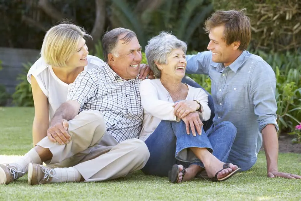 image of senior couple in garden with adult children for the post 10 Ways to Honor Your Parents as Adult Children