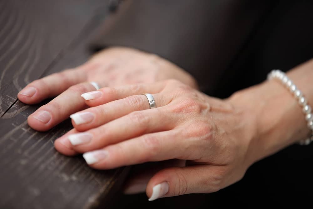 image of man and woman's hands together in church for the post The Fruit Of Her Hands - Honoring You Or Harming You?: Proverbs 31:31, A Closer Look