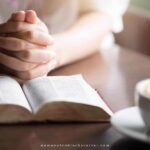 image of woman with hands folded by Bible and coffee cup on table for the post What is Christian meditation, An Easy How-To and 7 Tips for Impactful Meditation