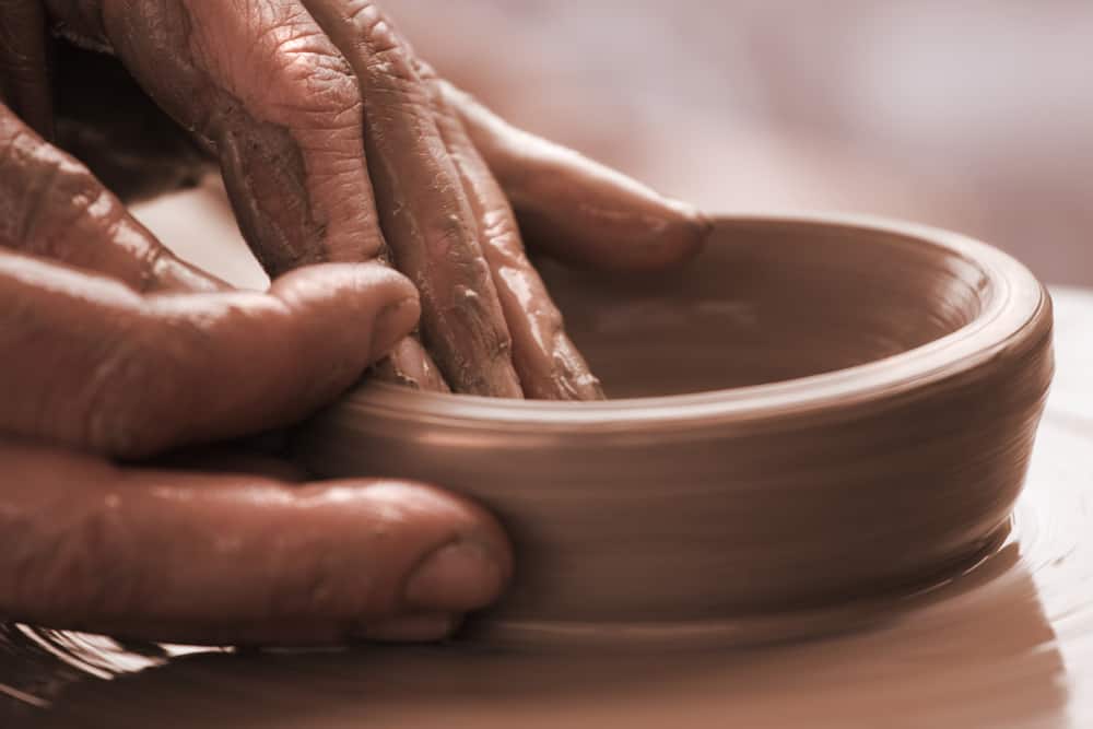 image of potter shaping clay for the post clay in the Bible