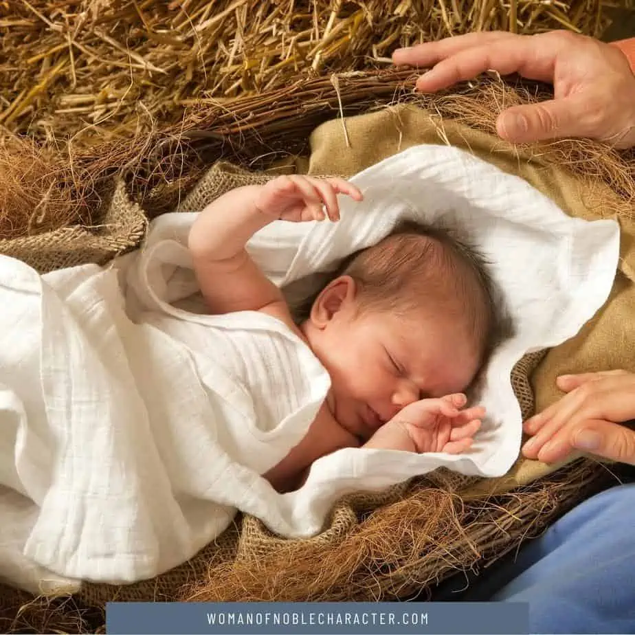 image of a baby in a blanket laying in hay