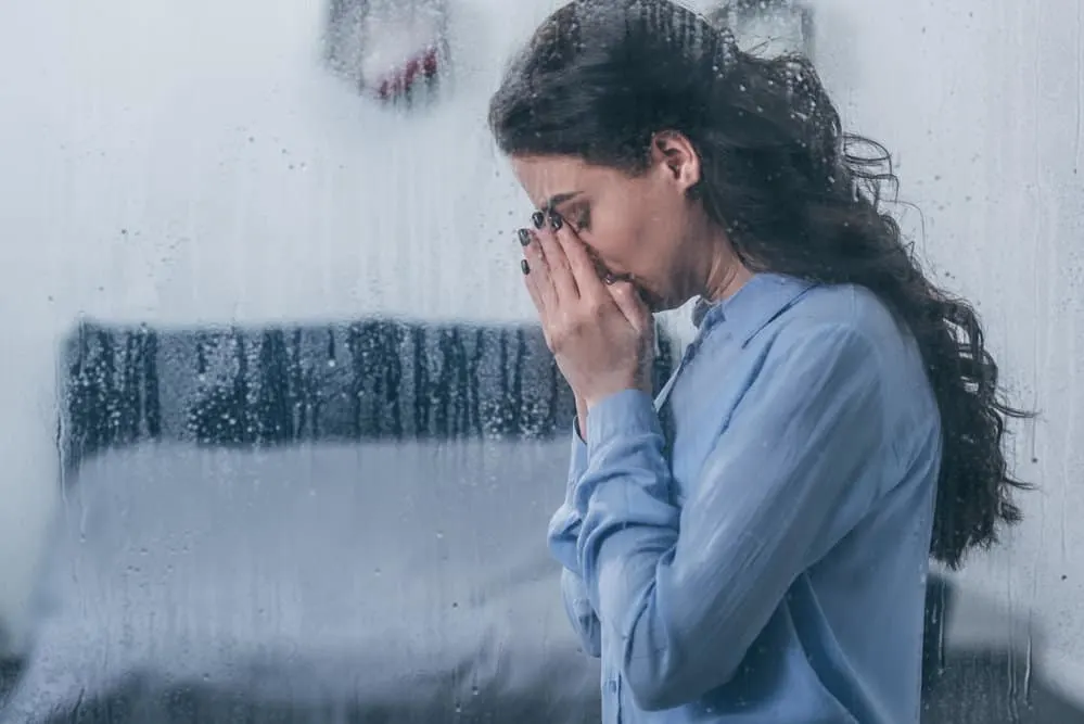 image of praying woman through window with rain for the post take thoughts captive