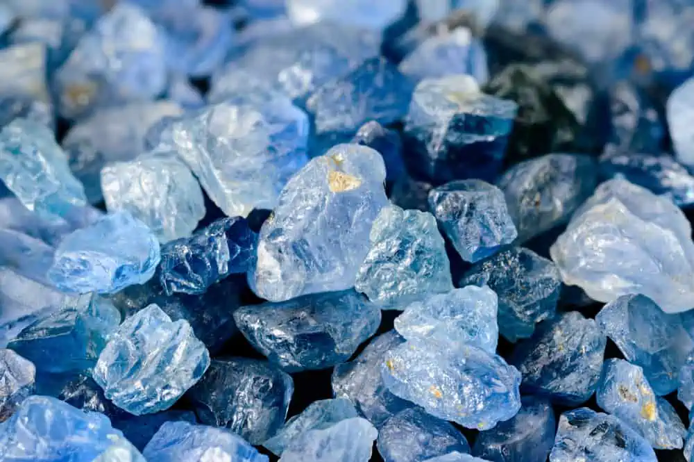 image of raw, uncut sapphires for the post The Color Blue in the Bible: Its Intriguing Significance