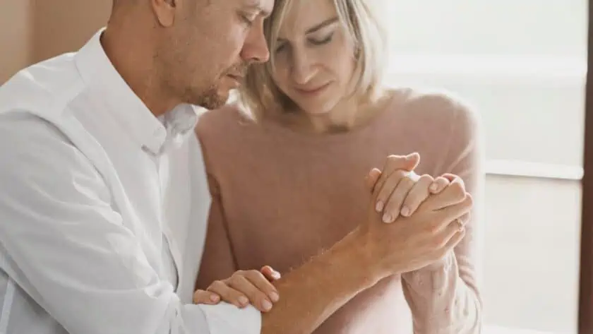 Image of husband and wife praying over the bible for the post how to love your wife as christ loves his church