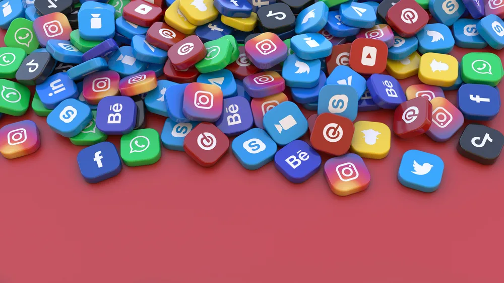 3d rendering of a bunch of square badges with the logo of the main social networks apps over red background for the post on social media fast