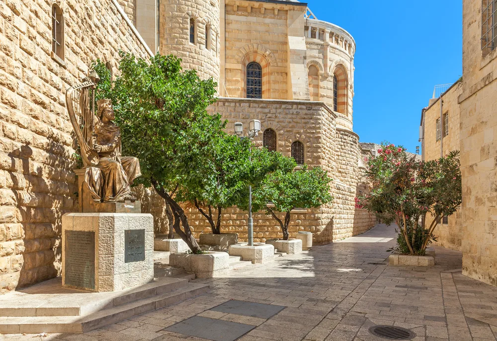 Sculpture of King David playing harp near entrance to his tomb on Mount Zion for post on Zion in the Bible