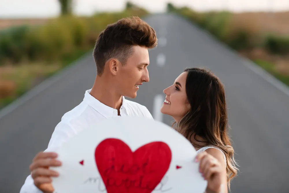 image of couple standing in roadway with heart that says just married for the post Marriage Preparation: 5 Crucial Steps to Take Before Getting Engaged