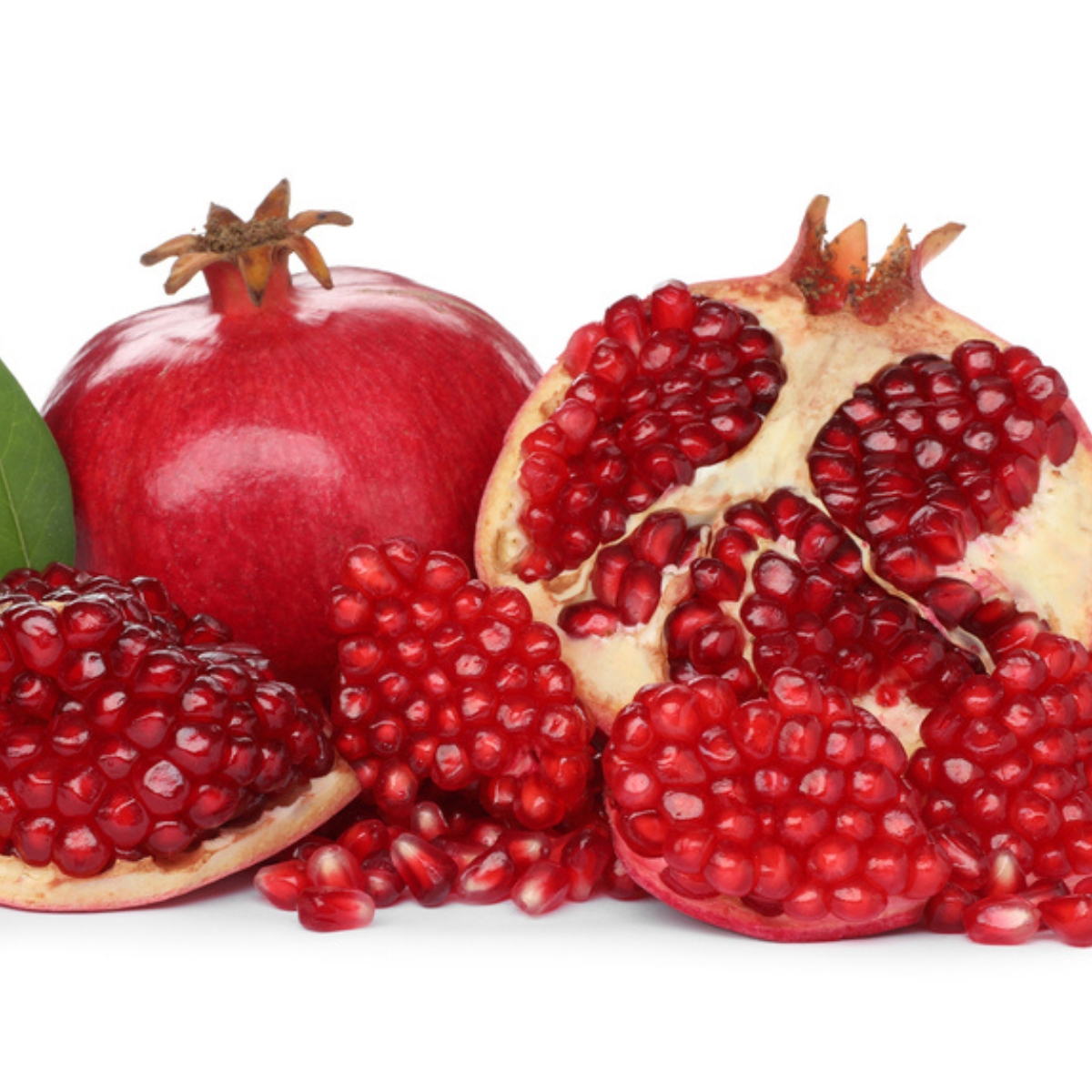 whole and cut pomegranates on white background for the post Pomegranates in the Bible, the significance of