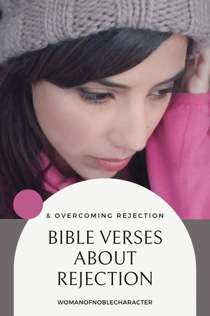 image of sad woman in hot pink coat and grey hat with the text Bible verses about rejection and overcoming rejection