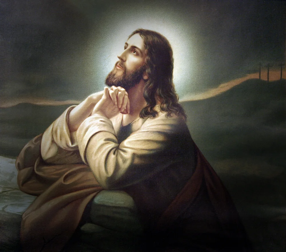 image of Jesus with hands folded and looking up to heaven for the post Hebrew name for Jesus