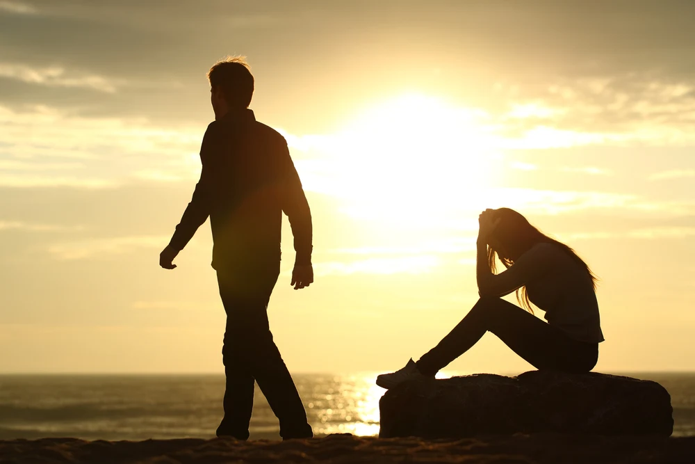 Couple silhouette breaking up a relation on the beach at sunset for the post Bible verses about rejection